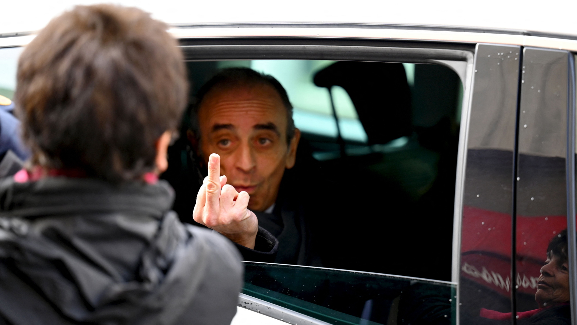 Eric Zemmour zeigt aus dem Auto einer Frau den Mittelfinger. | AFP