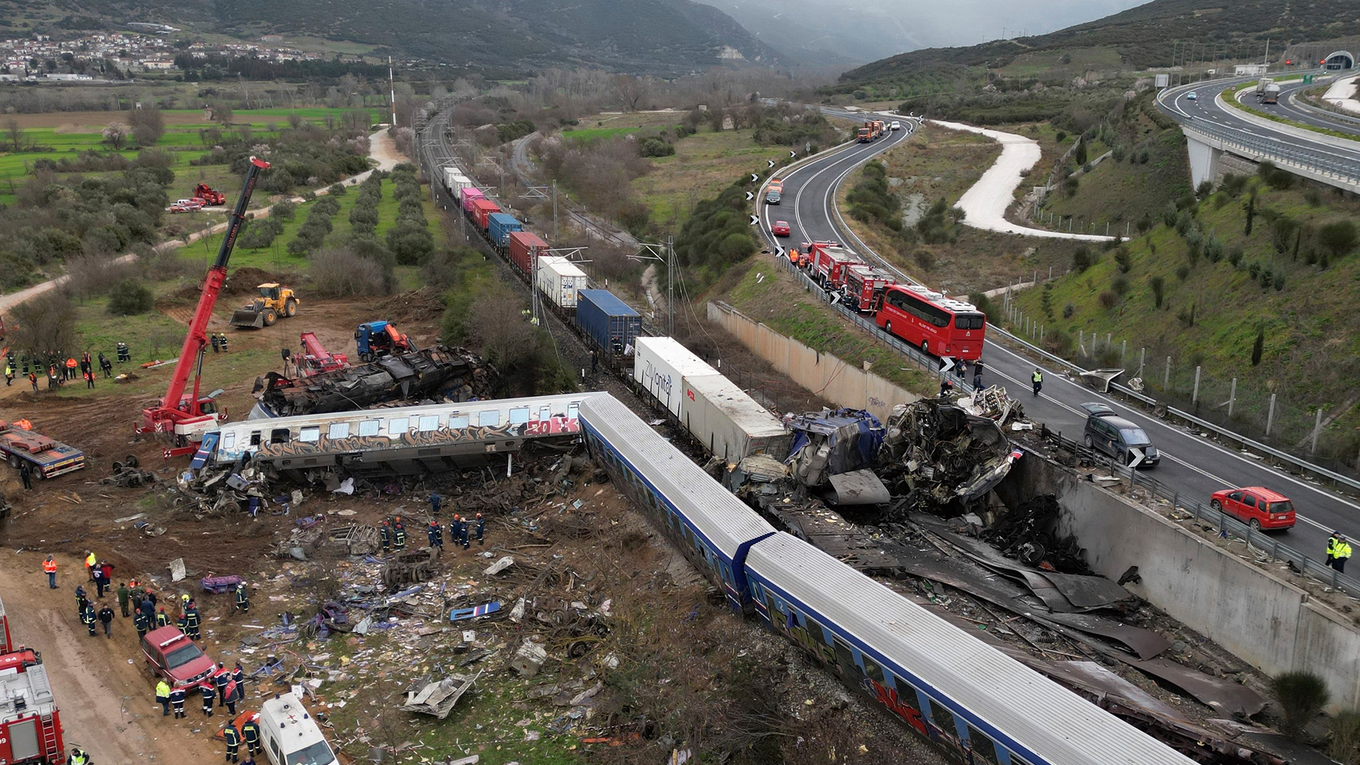 Ein Kran, Feuerwehrleute und Retter arbeiten nach einem Zusammenstoß zweier Züge in Tempe in der Nähe der Stadt Larissa (Griechenland). | AP