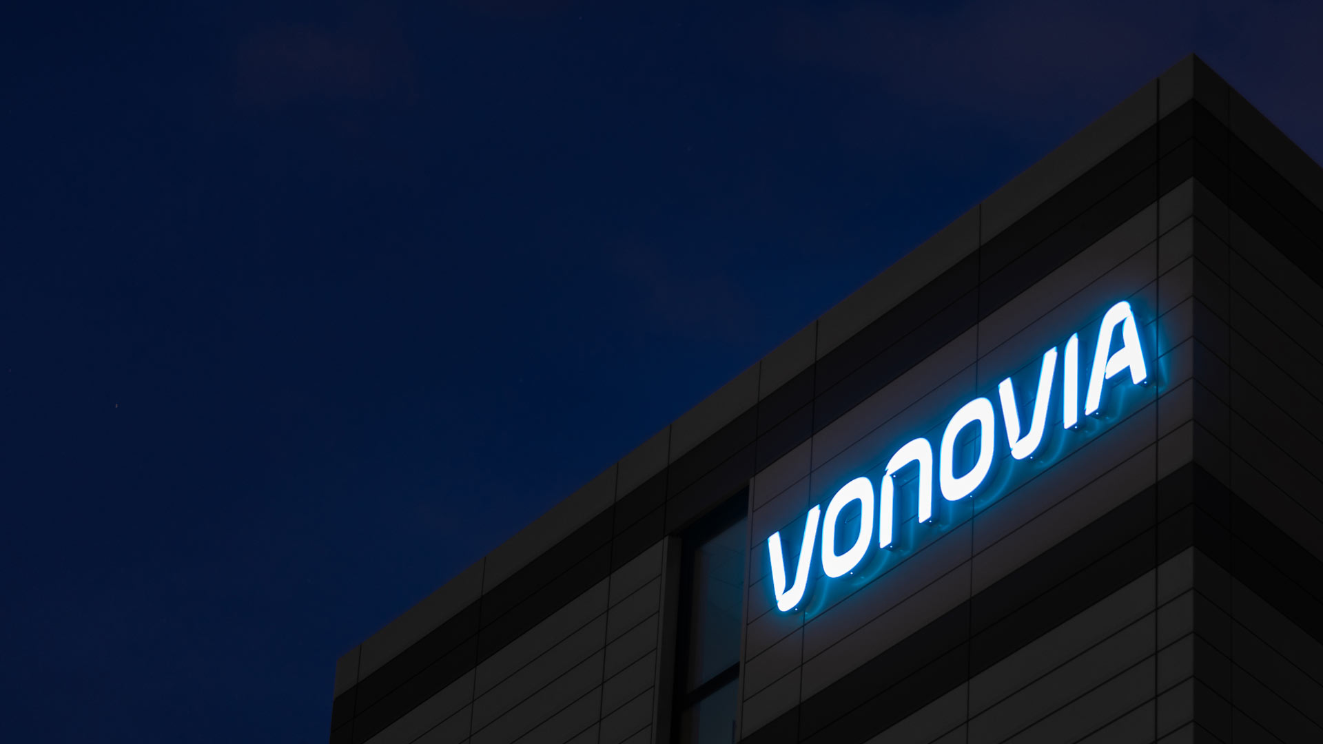 Der Schriftzug des Wohnungsunternehmens «Vonovia» leuchtet an der Firmenzentrale