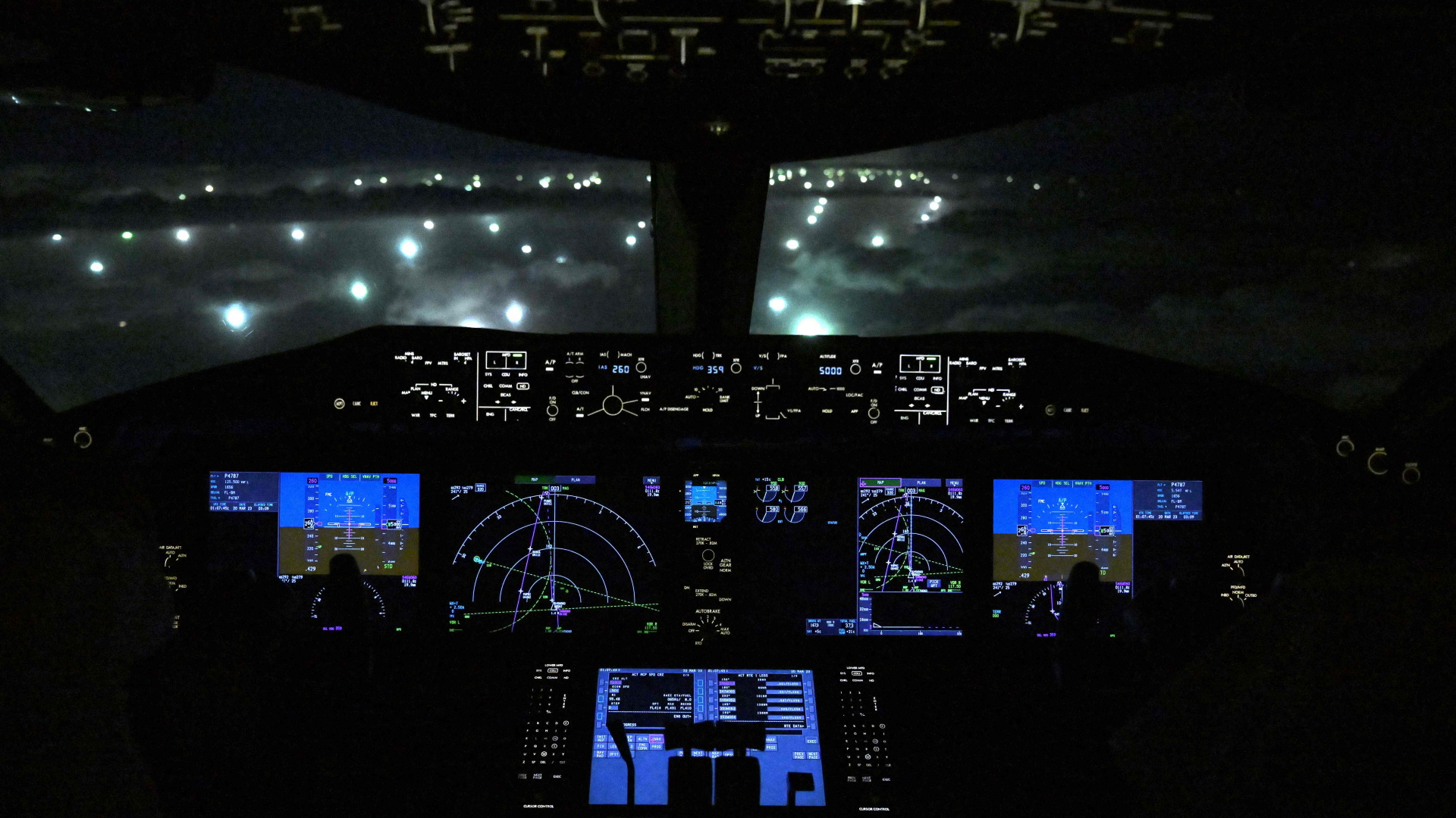 Der Blick aus einem Flugzeug-Cockpit auf Fischerboote, die in der ausschließlichen Wirtschaftszone Argentiniens mithilfe von Licht auf Tintenfischfang gehen | AFP