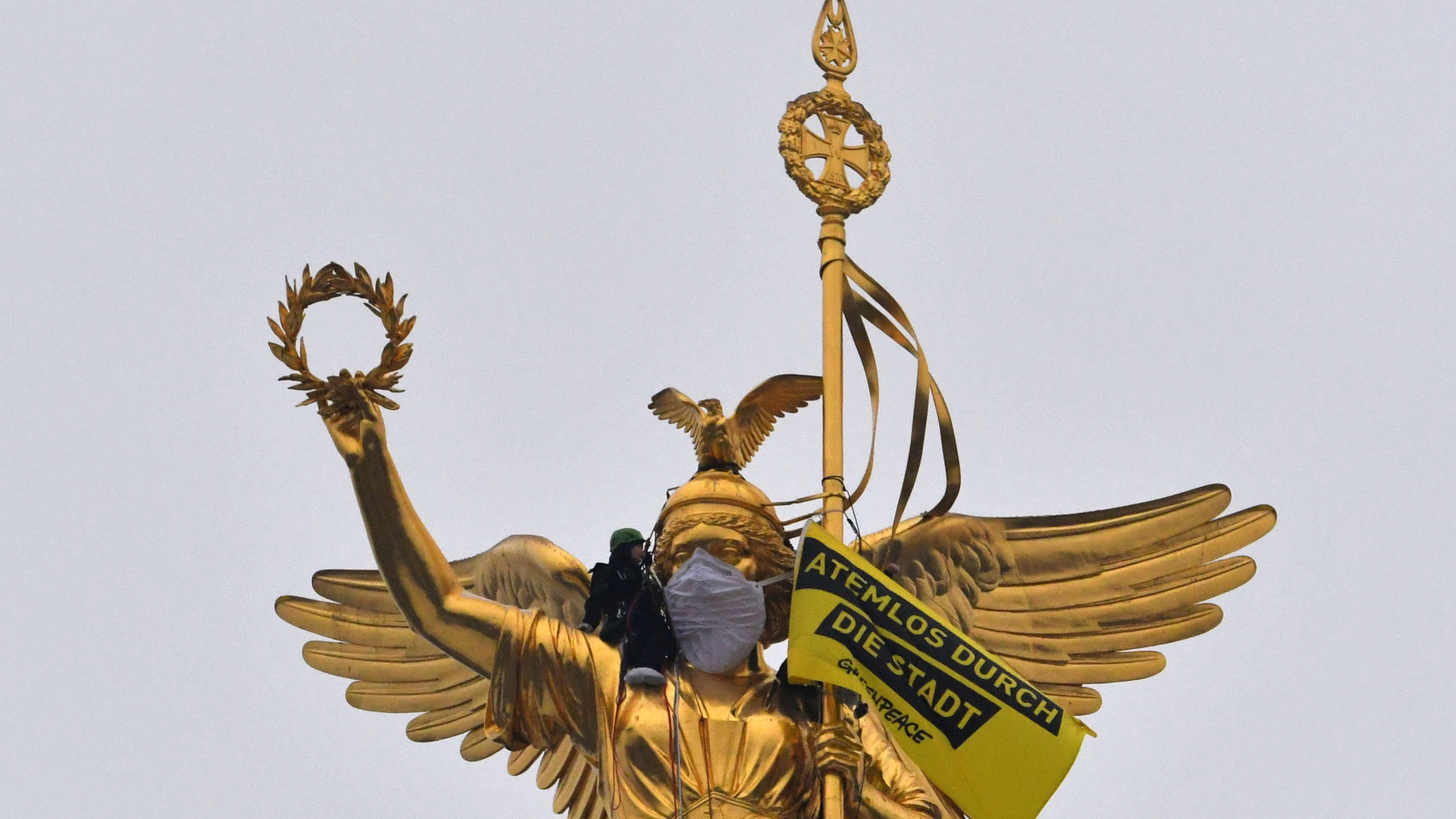 Bei einer Protestaktion gegen die hohe Umweltverschmutzung hat Greenpeace der Berliner Siegessäule eine Atemschutzmaske verpasst. | dpa