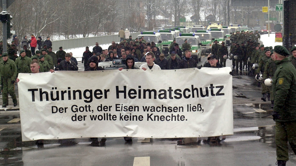 Mitglieder des "Thüringer Heimatschutz" halten auf einer Demonstration ein Transparent mit der Aufschrift "Der Gott, der Eisen wachsen ließ, der wollte keine Knechte".  | picture-alliance / dpa/dpaweb