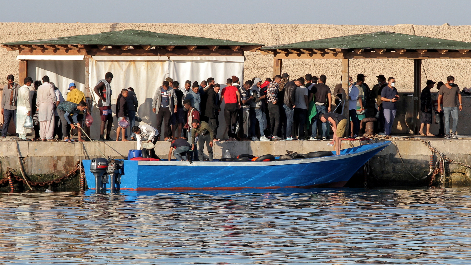 Migranten gehen auf der italienischen Insel Lampedusa an Land. | REUTERS